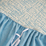 Stormy Blue Jacquard sofa cover styled with cushions on a low-back sofa