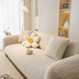 Grey Knit sofa cover draped over a three-seater sofa in a bright living room, view 2