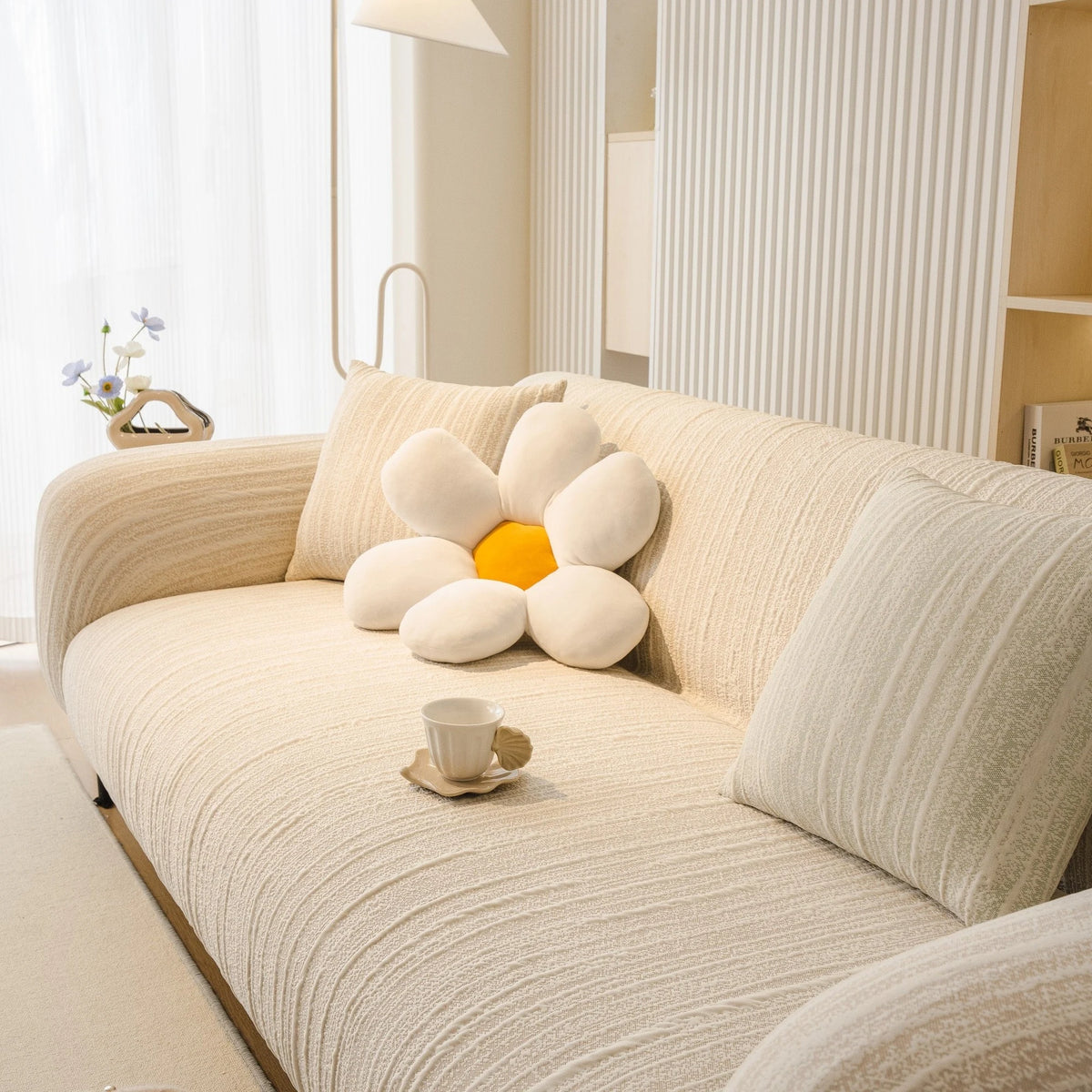 Ivory Cream Knit sofa cover draped over a three-seater sofa in a bright living room