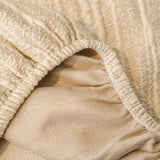 Ivory Cream Knit sofa cover covering the arm and seat of a sectional