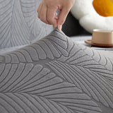 Stone Grey Palm Relief sofa cover styled with cushions on a low-back sofa, view 4