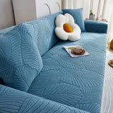 Stormy Blue Palm Relief sofa cover seen from the side on a corner sofa