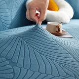 Stormy Blue Palm Relief sofa cover styled with cushions on a low-back sofa