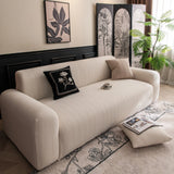 Ivory Cream Pinstripe Knit sofa cover draped over a three-seater sofa in a bright living room