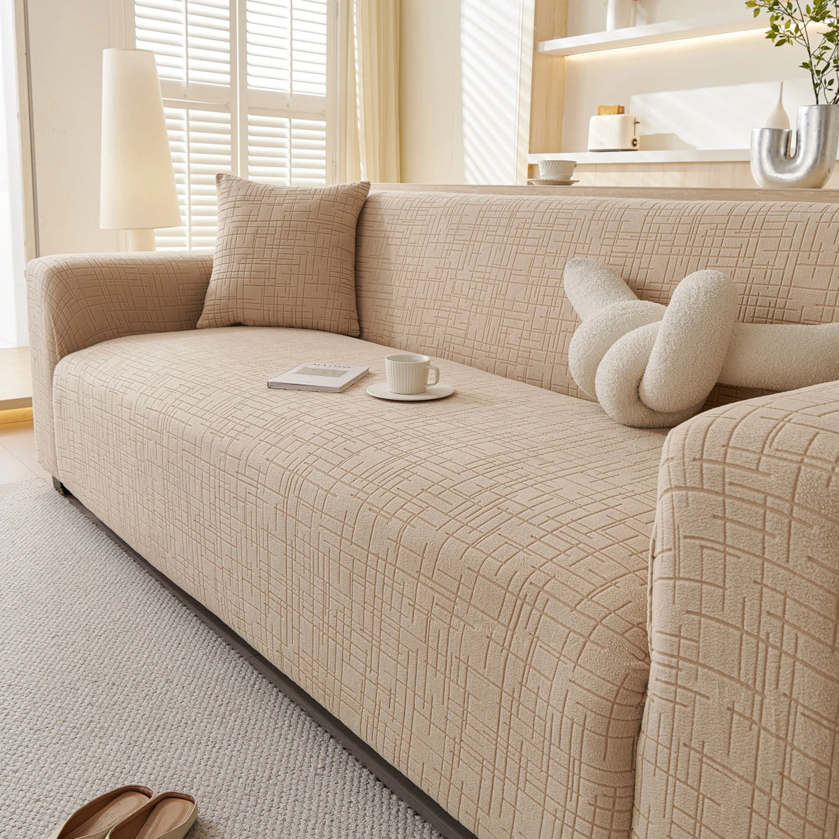 Boucle-Style Sand Quilted Waffle sofa cover draped over a three-seater sofa in a bright living room, view 5
