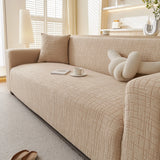 Boucle-Style Sand Quilted Waffle sofa cover draped over a three-seater sofa in a bright living room, view 5