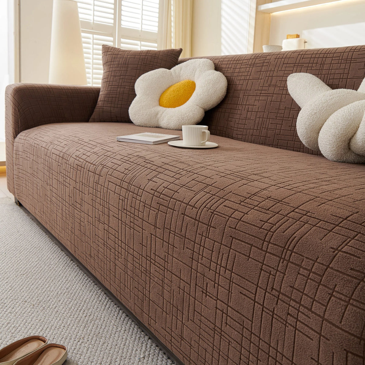 Brown Quilted Waffle sofa cover draped over a three-seater sofa in a bright living room, view 2