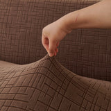 Brown Quilted Waffle sofa cover styled with cushions on a low-back sofa, view 2