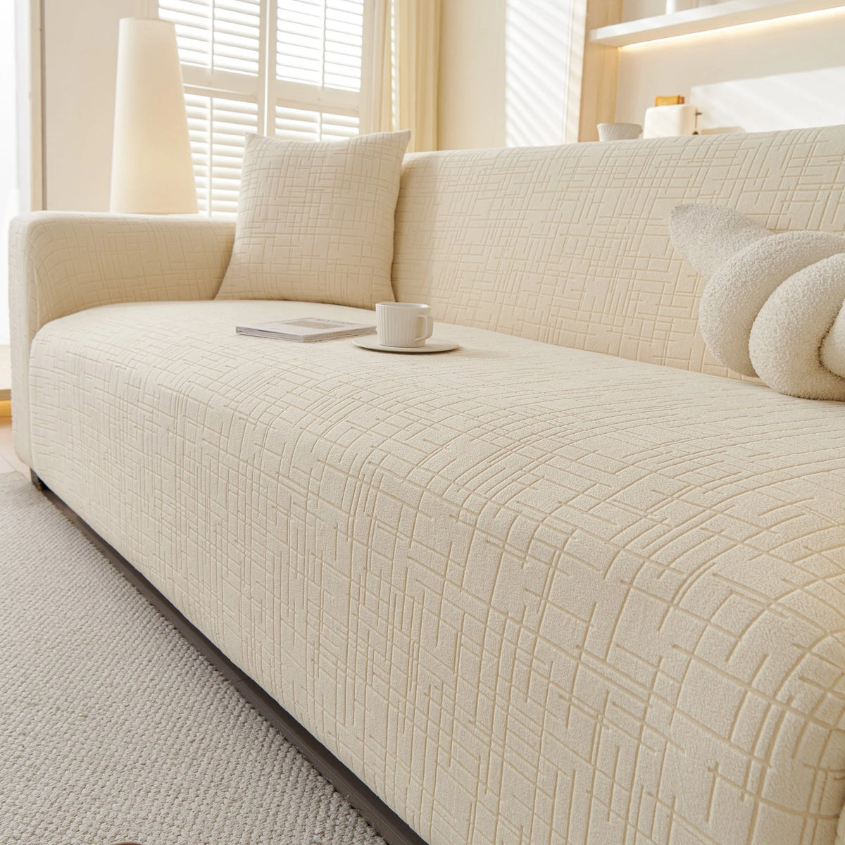 Cream Beige Quilted Waffle sofa cover draped over a three-seater sofa in a bright living room