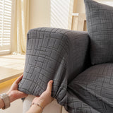 Stone Grey Quilted Waffle sofa cover styled with cushions on a low-back sofa, view 6