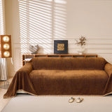 Coffee Brown Corduroy sofa throw draped over a three-seater sofa in a bright living room, view 2