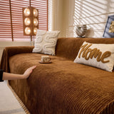 Coffee Brown Corduroy sofa throw photographed at an angle beside a floor lamp