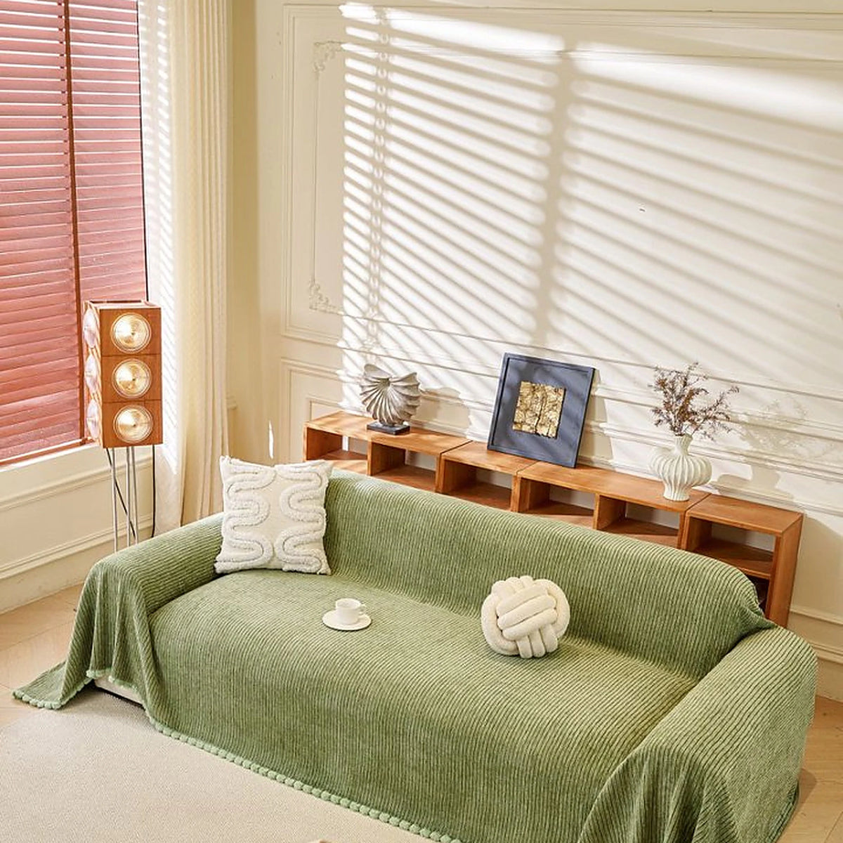 Sage Mist Corduroy sofa throw draped over a three-seater sofa in a bright living room, view 3