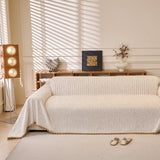 Oat Beige Corduroy sofa throw draped over a three-seater sofa in a bright living room
