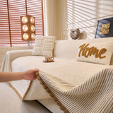 Oat Beige Corduroy sofa throw shown across the seat and backrest of a two-seater