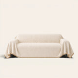 Oat Beige Corduroy sofa throw on a plain studio background