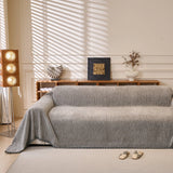 Stone Grey Corduroy sofa throw draped over a three-seater sofa in a bright living room, view 5