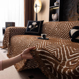 Auburn Brown Geometric Boho sofa throw styled with cushions on a low-back sofa, view 2
