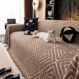 Warm Stone Geometric Boho sofa throw seen from the side on a corner sofa, view 5