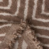 Warm Stone Geometric Boho sofa throw photographed at an angle beside a floor lamp, view 5