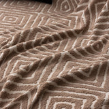 Warm Stone Geometric Boho sofa throw spread across a sofa in daylight, view 5