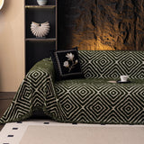 Forest Green Geometric Boho sofa throw draped over a three-seater sofa in a bright living room, view 4