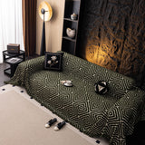 Forest Green Geometric Boho sofa throw shown across the seat and backrest of a two-seater, view 4