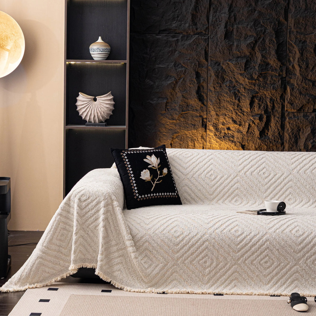 Ivory Cream Geometric Boho sofa throw draped over a three-seater sofa in a bright living room, view 3