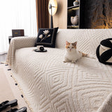 Ivory Cream Geometric Boho sofa throw seen from the side on a corner sofa, view 3