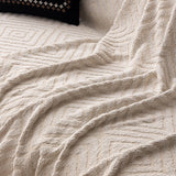 Ivory Cream Geometric Boho sofa throw shown across the seat and backrest of a two-seater, view 3
