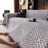 Pearl Grey Geometric Boho sofa throw seen from the side on a corner sofa