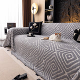 Pearl Grey Geometric Boho sofa throw shown across the seat and backrest of a two-seater