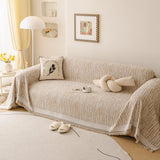 Caramel Linen Knit sofa throw draped over a three-seater sofa in a bright living room, view 2
