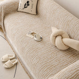 Caramel Linen Knit sofa throw photographed at an angle beside a floor lamp