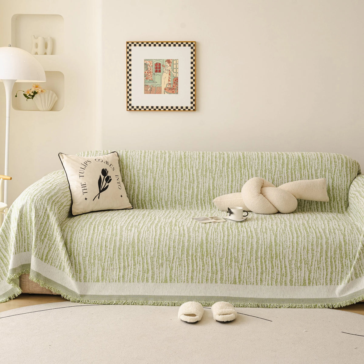 Forest Green Linen Knit sofa throw draped over a three-seater sofa in a bright living room, view 3