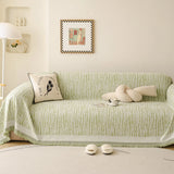 Forest Green Linen Knit sofa throw draped over a three-seater sofa in a bright living room, view 3