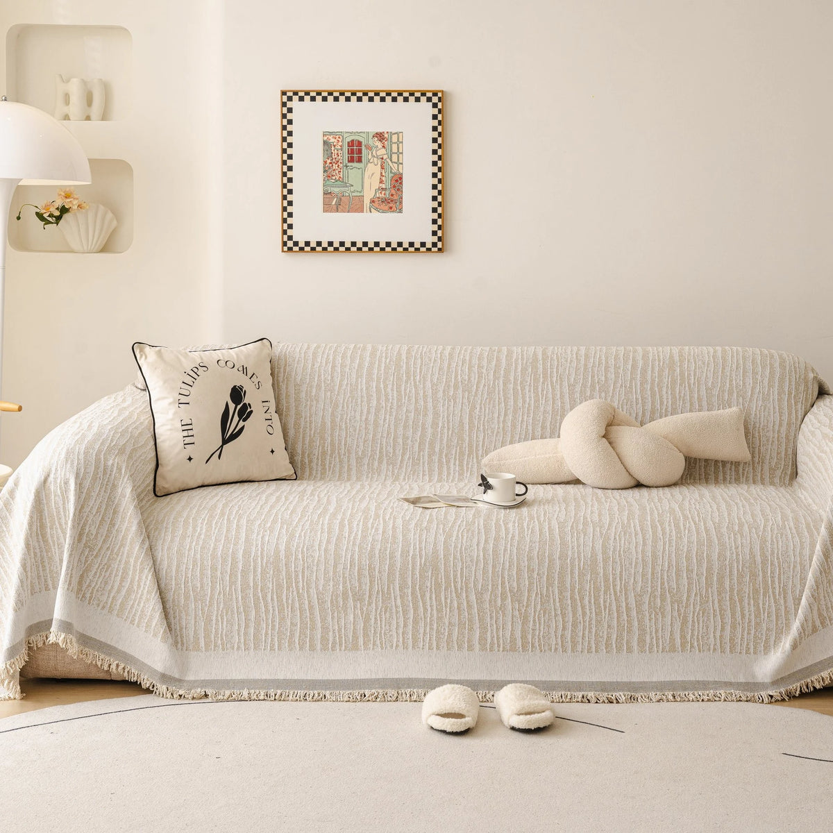 Khaki Linen Knit sofa throw draped over a three-seater sofa in a bright living room, view 4