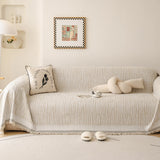 Khaki Linen Knit sofa throw draped over a three-seater sofa in a bright living room, view 4