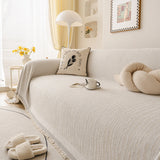 Oat Beige Linen Knit sofa throw draped over a three-seater sofa in a bright living room