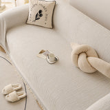Oat Beige Linen Knit sofa throw seen from the side on a corner sofa