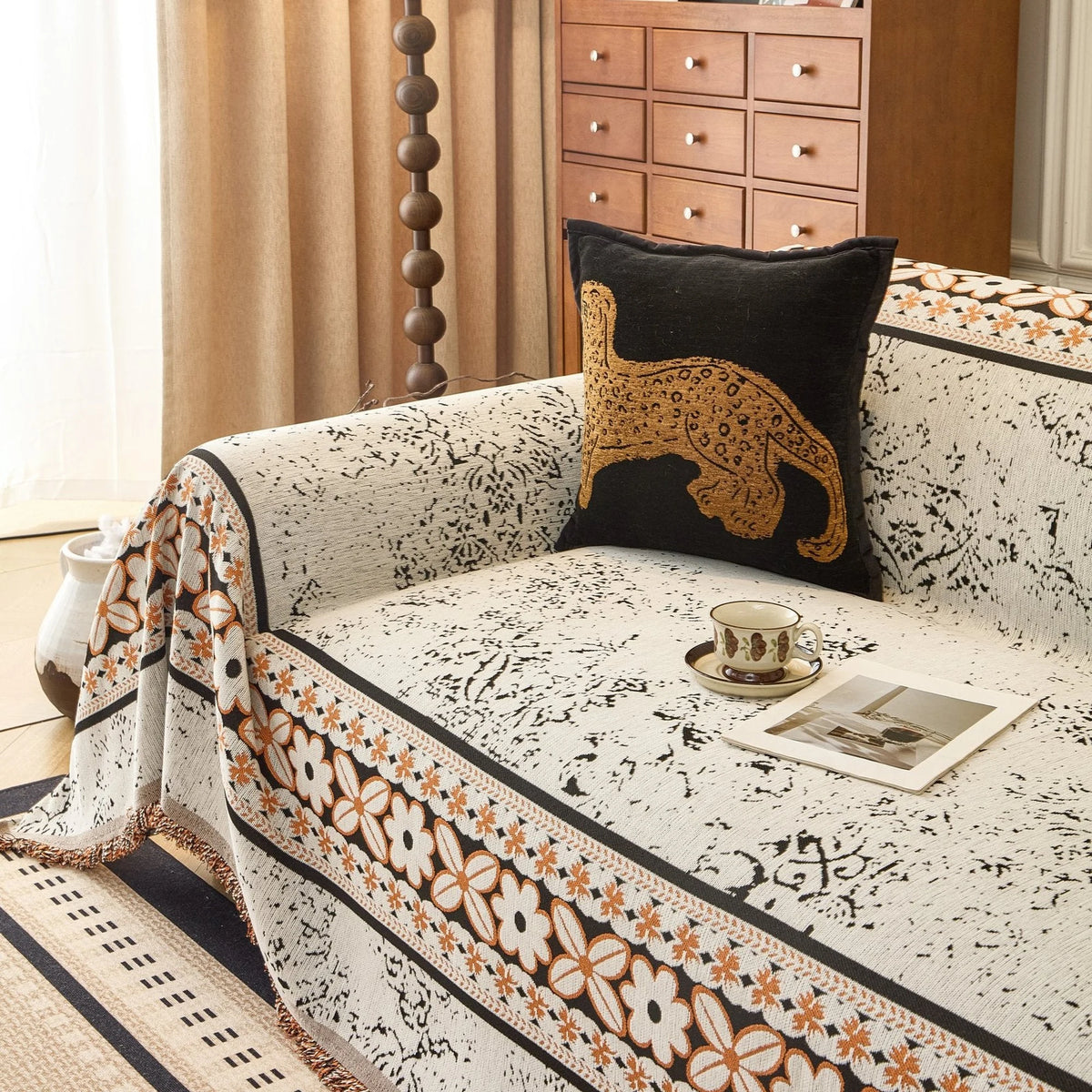 Ivory Cream Luxe Heritage sofa throw draped over a three-seater sofa in a bright living room, view 2