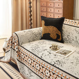 Ivory Cream Luxe Heritage sofa throw draped over a three-seater sofa in a bright living room, view 2