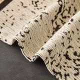 Ivory Cream Luxe Heritage sofa throw spread across a sofa in daylight, view 2