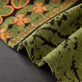 Olive Green Luxe Heritage sofa throw photographed at an angle beside a floor lamp, view 3
