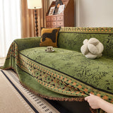 Olive Green Luxe Heritage sofa throw shown on a straight sofa against a pale wall, view 3