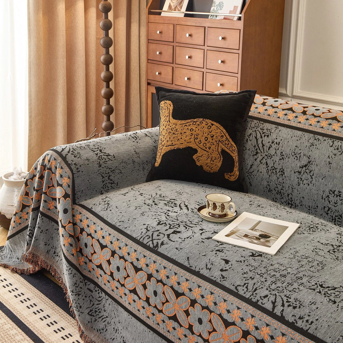 Pearl Grey Luxe Heritage sofa throw draped over a three-seater sofa in a bright living room