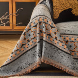 Pearl Grey Luxe Heritage sofa throw styled with cushions on a low-back sofa
