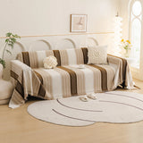 Auburn Brown Metro Stripe sofa throw draped over a three-seater sofa in a bright living room