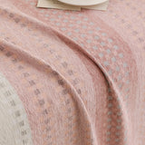 Blush Pink Metro Stripe sofa throw styled with cushions on a low-back sofa, view 3