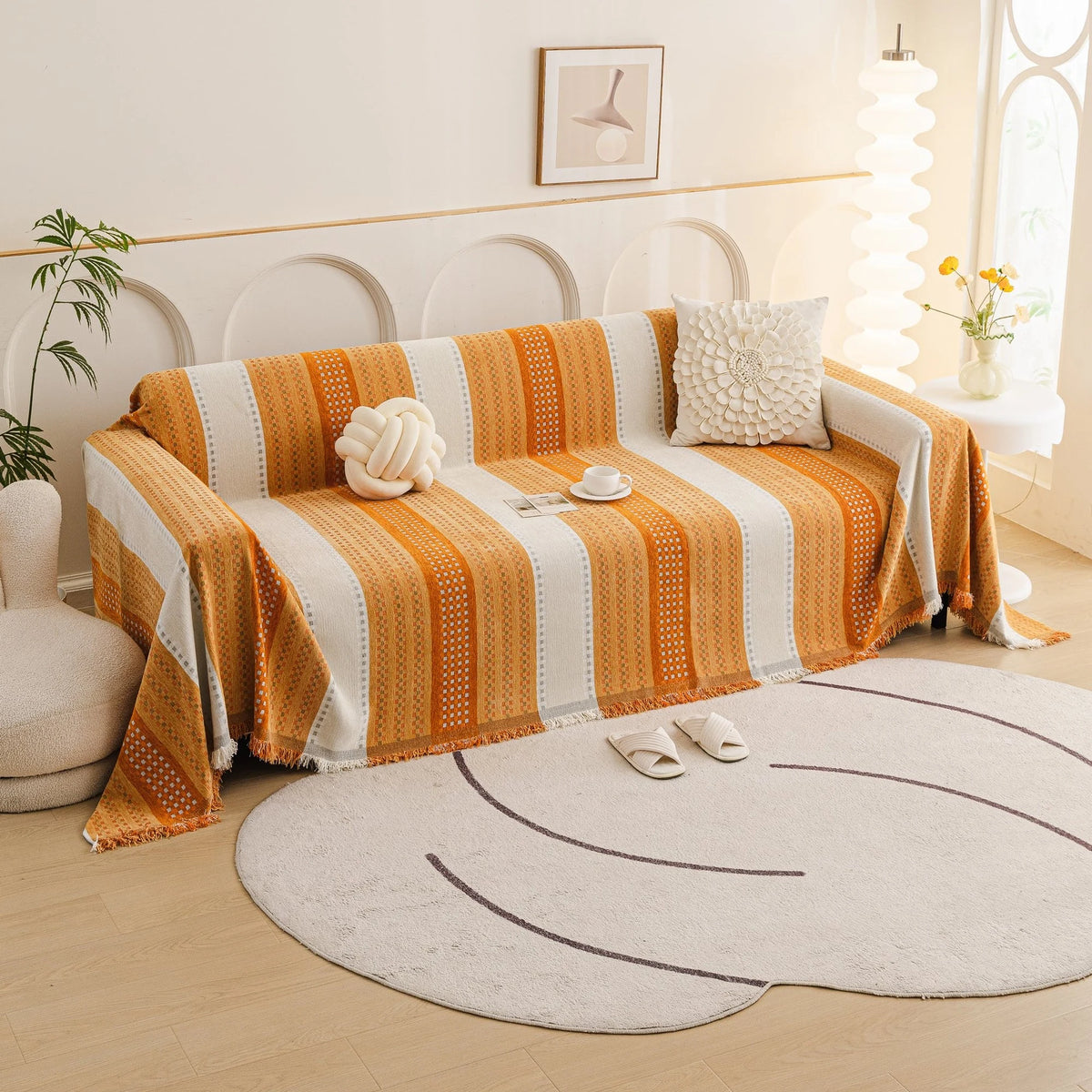 Orange Arrow Metro Stripe sofa throw draped over a three-seater sofa in a bright living room, view 4